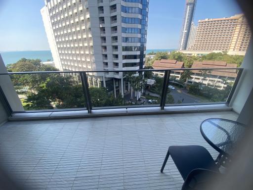 Spacious balcony with a view of the ocean and surrounding buildings