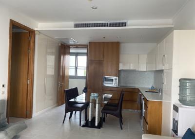 Modern open-plan living and dining area with kitchen appliances