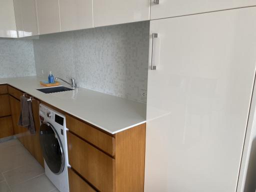 Modern kitchen with stainless steel sink and wooden cabinets