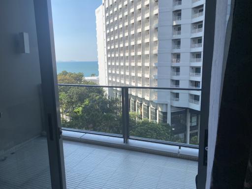 Seaside apartment balcony view with neighboring building