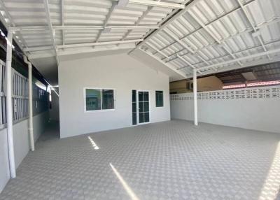 Spacious garage with tiled flooring and ample lighting