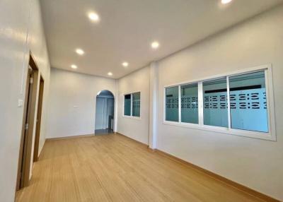 Spacious unfurnished room with hardwood flooring and natural light