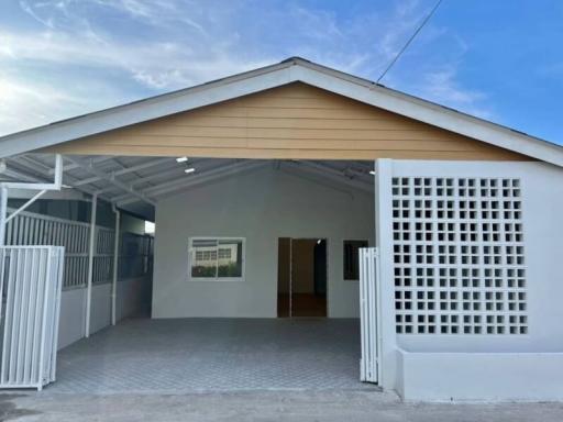 Front view of a modern house with carport and fence