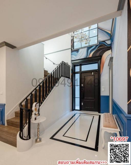 Elegant interior view of a building entryway with a staircase and artistic wall murals