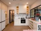 Modern kitchen with white cabinetry and stainless steel appliances