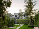 Elegant residential home with manicured garden and lawn during twilight