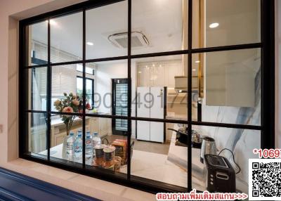 Modern kitchen interior with glass partition and dining area