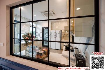 Modern kitchen interior with glass partition and dining area