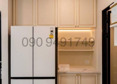 Compact kitchen space with refrigerator and cabinets