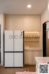 Compact kitchen space with refrigerator and cabinets