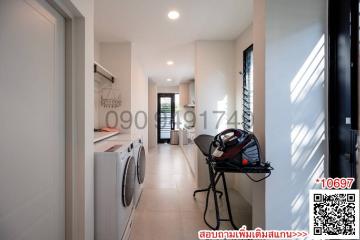 Modern hallway interior with laundry appliances and storage space