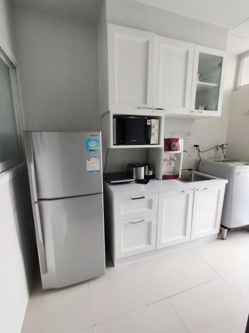 Modern kitchen with white cabinetry and stainless steel appliances