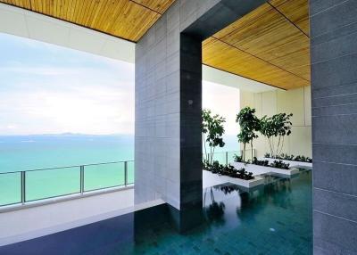 Modern building interior with ocean view, open space, and high ceiling