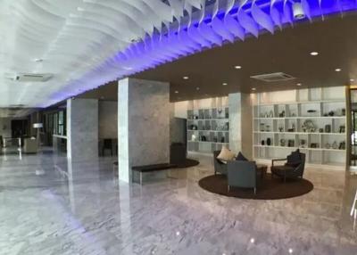 Modern lobby interior with artistic ceiling and marble floors