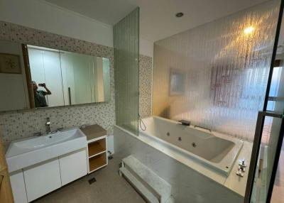 Modern bathroom with a bathtub and glass shower