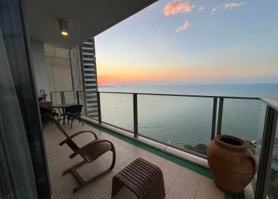 Spacious balcony with ocean view at sunset
