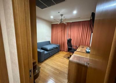 Cozy bedroom with a dedicated workspace and hardwood flooring