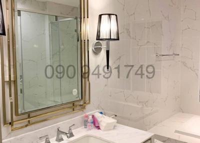 Elegant bathroom interior with marble finishes and modern lighting