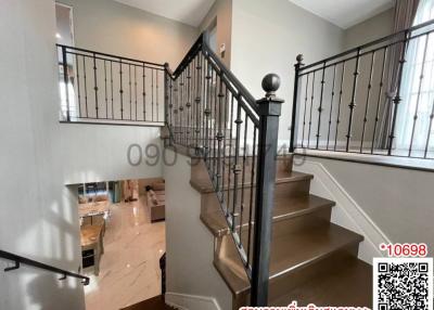 Elegant staircase with wooden steps and wrought iron balusters