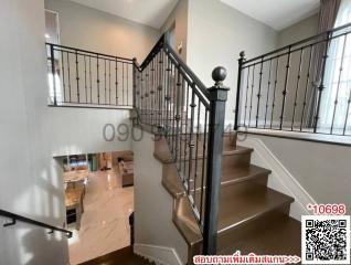 Elegant staircase with wooden steps and wrought iron balusters