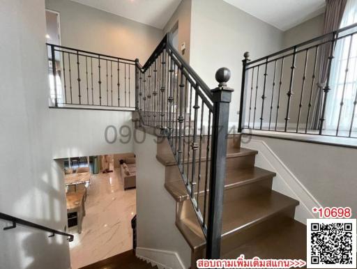 Elegant staircase with wooden steps and wrought iron balusters