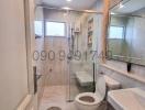 Modern bathroom with glass shower and marble tiles