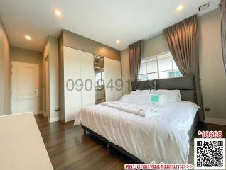 Spacious bedroom with modern furnishings and ample lighting