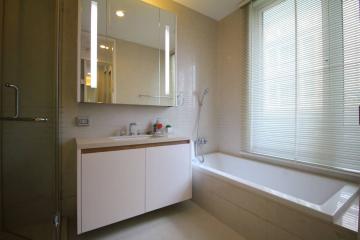 Modern bathroom with ample lighting and a bathtub