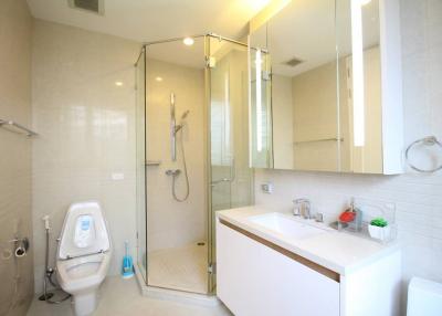 Modern bathroom with a walk-in shower and white interior