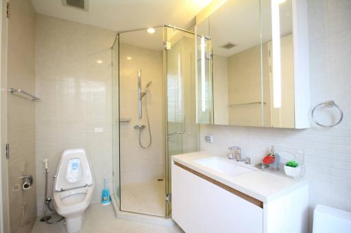 Modern bathroom with a walk-in shower and white interior