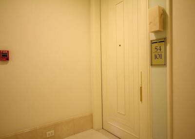 Compact entryway with neutral wall colors and fire safety equipment