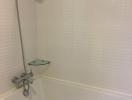 Clean white tiled bathroom with shower