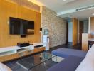 Modern living room with wooden wall paneling and an entertainment unit