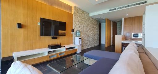 Modern living room with wooden wall paneling and an entertainment unit