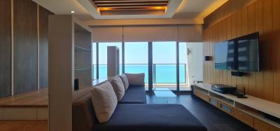 Modern living room with sea view, sleek furniture, and flat screen TV