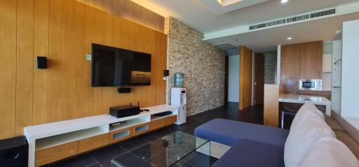 Modern living room with wood paneling and integrated entertainment system