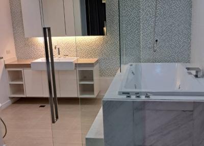 Modern bathroom with glass shower and marble tub