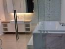 Modern bathroom with glass shower and marble tub