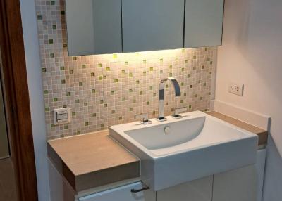 Modern bathroom with mosaic tiles and sleek vanity