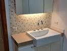 Modern bathroom with mosaic tiles and sleek vanity