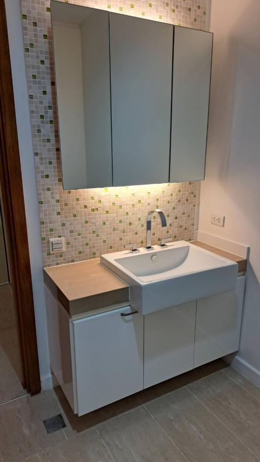 Modern bathroom with mosaic tiles and sleek vanity