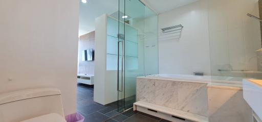 Modern bathroom with marble finishes and glass shower