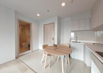 Modern kitchen with an adjoining dining area in a bright apartment