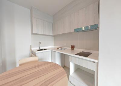 Modern white kitchen with wooden details and contemporary appliances