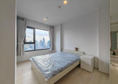 Modern bedroom with city view and natural lighting