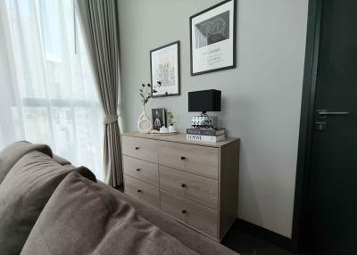 Cozy bedroom interior with decorative dresser and artwork