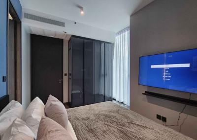 Modern bedroom with large bed and flat-screen TV