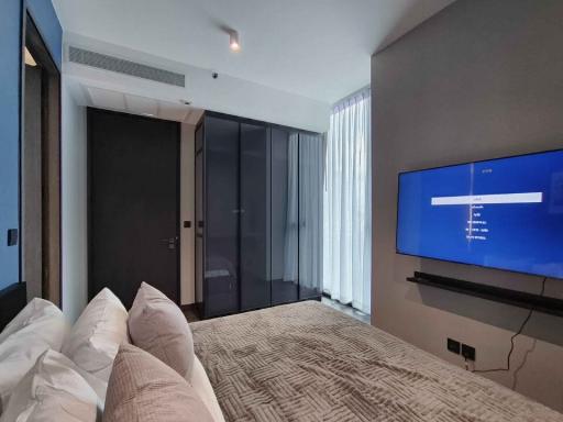 Modern bedroom with large bed and flat-screen TV