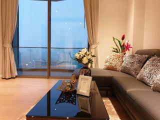 Spacious living room with large windows and city view