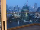 City skyline view from a high-rise apartment's living space at dusk